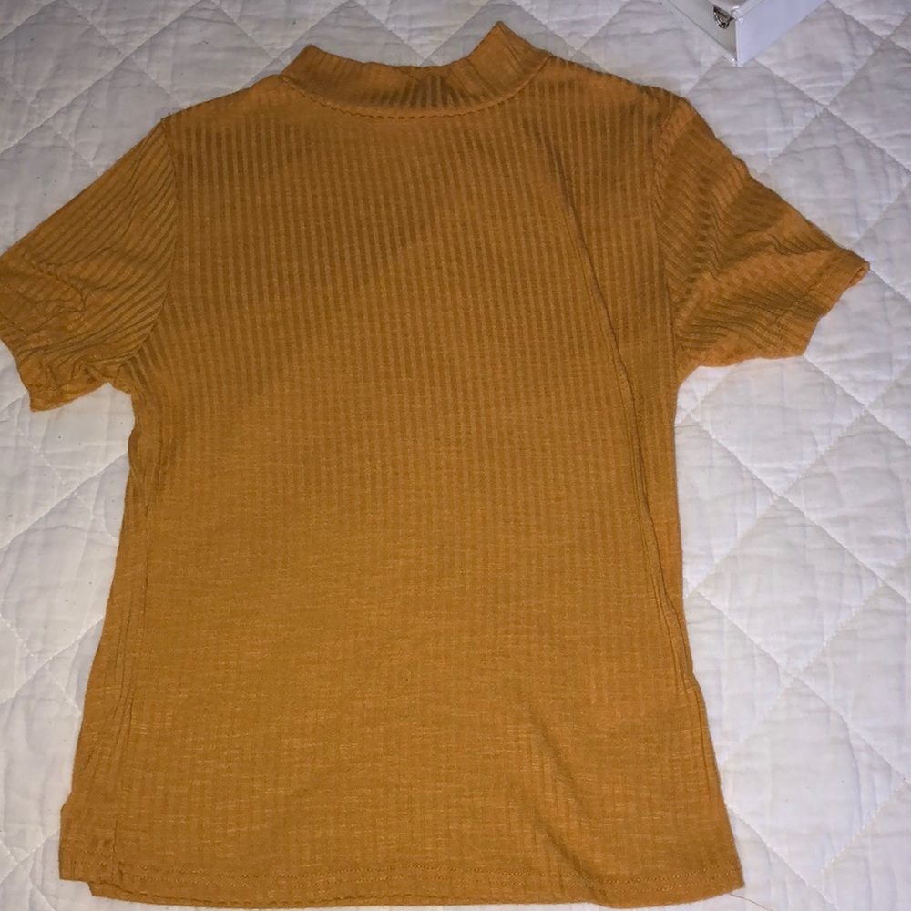 A mustard yellow short sleeved T-shirt